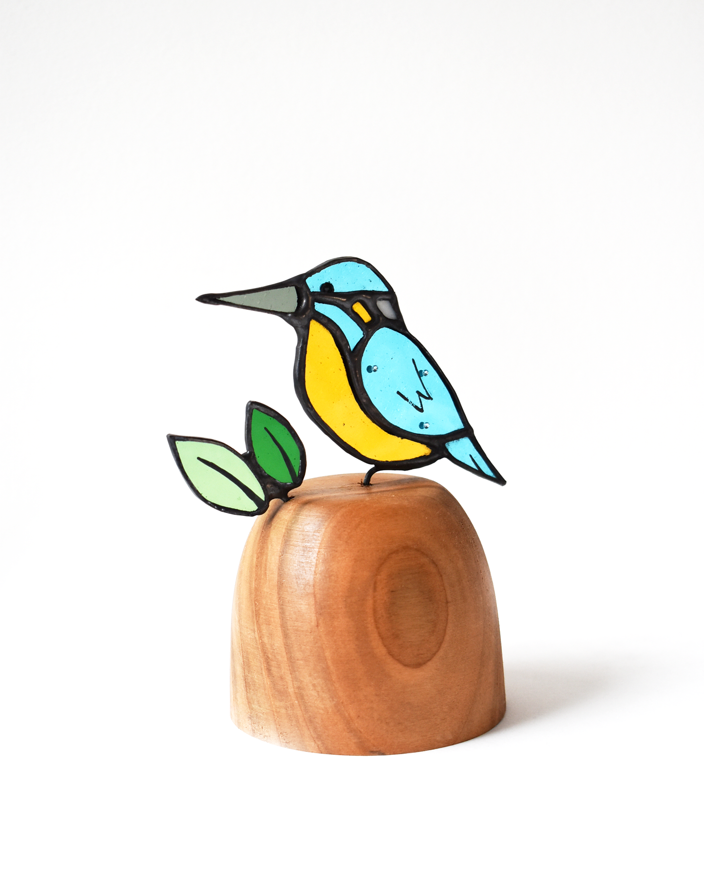 Decorative bird figurine on a wooden base with a white background