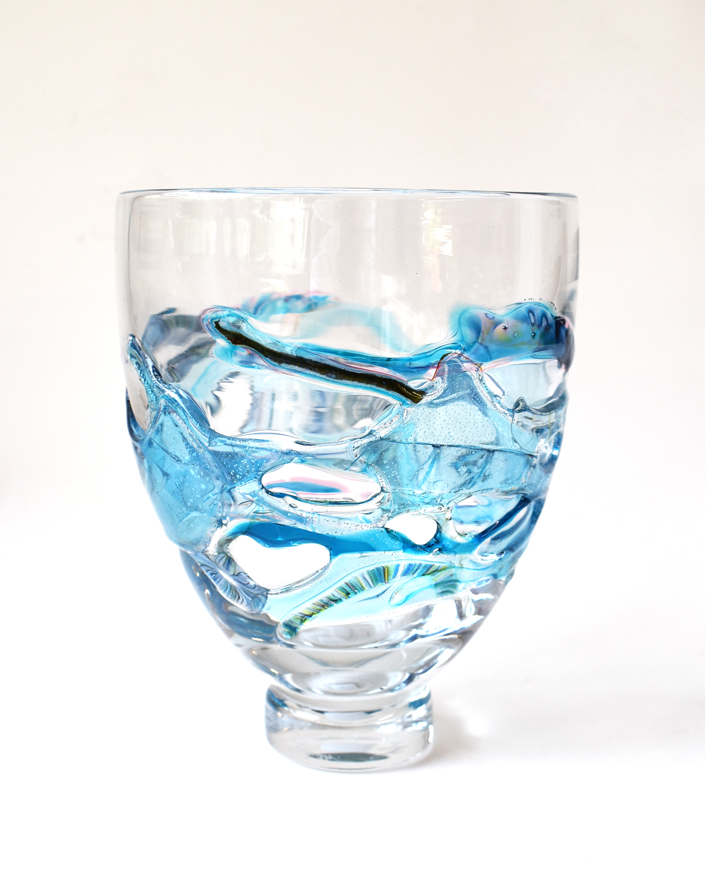 Glass vase with blue and clear design on a white background