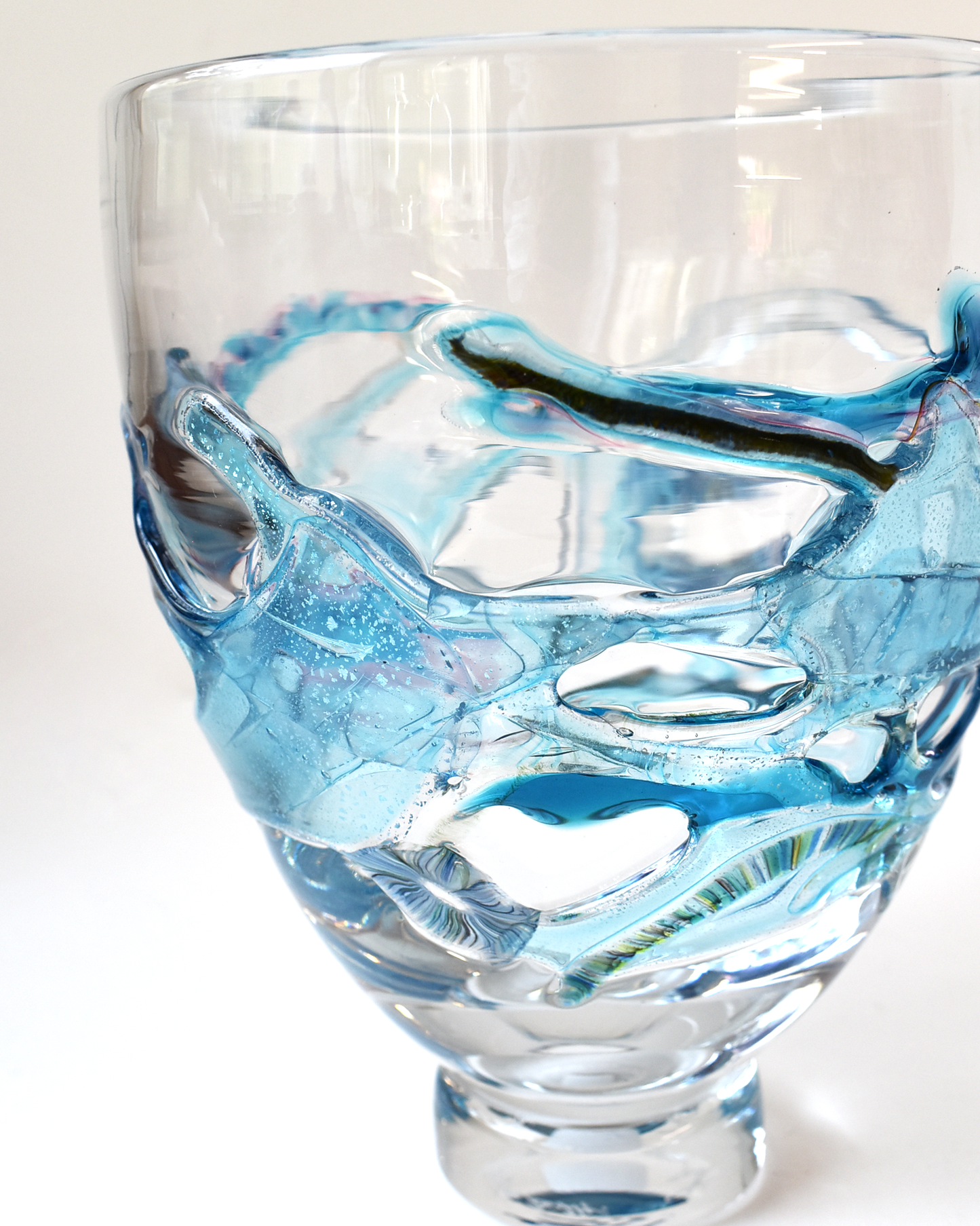 Clear glass with blue interior on a white background