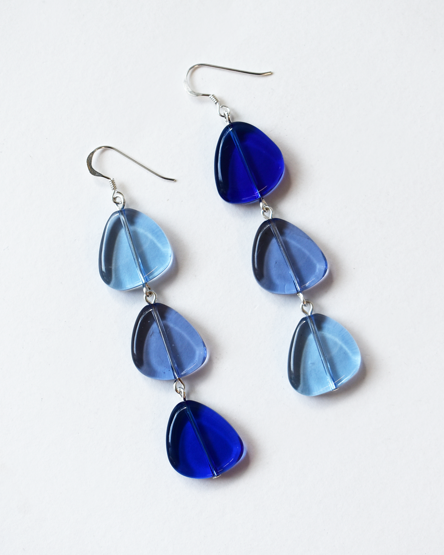 Blue teardrop earrings on a white background