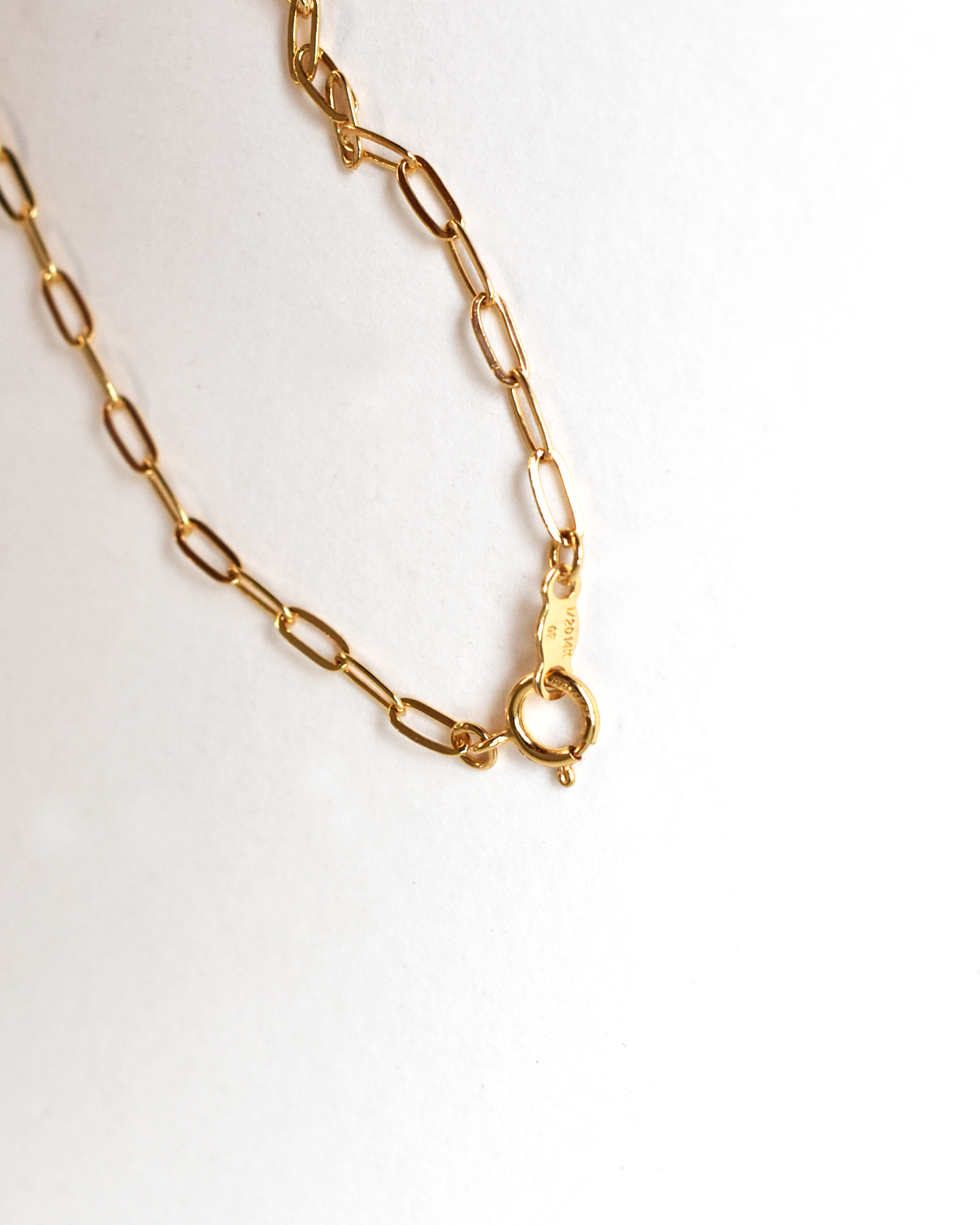 Gold chain necklace on a white background