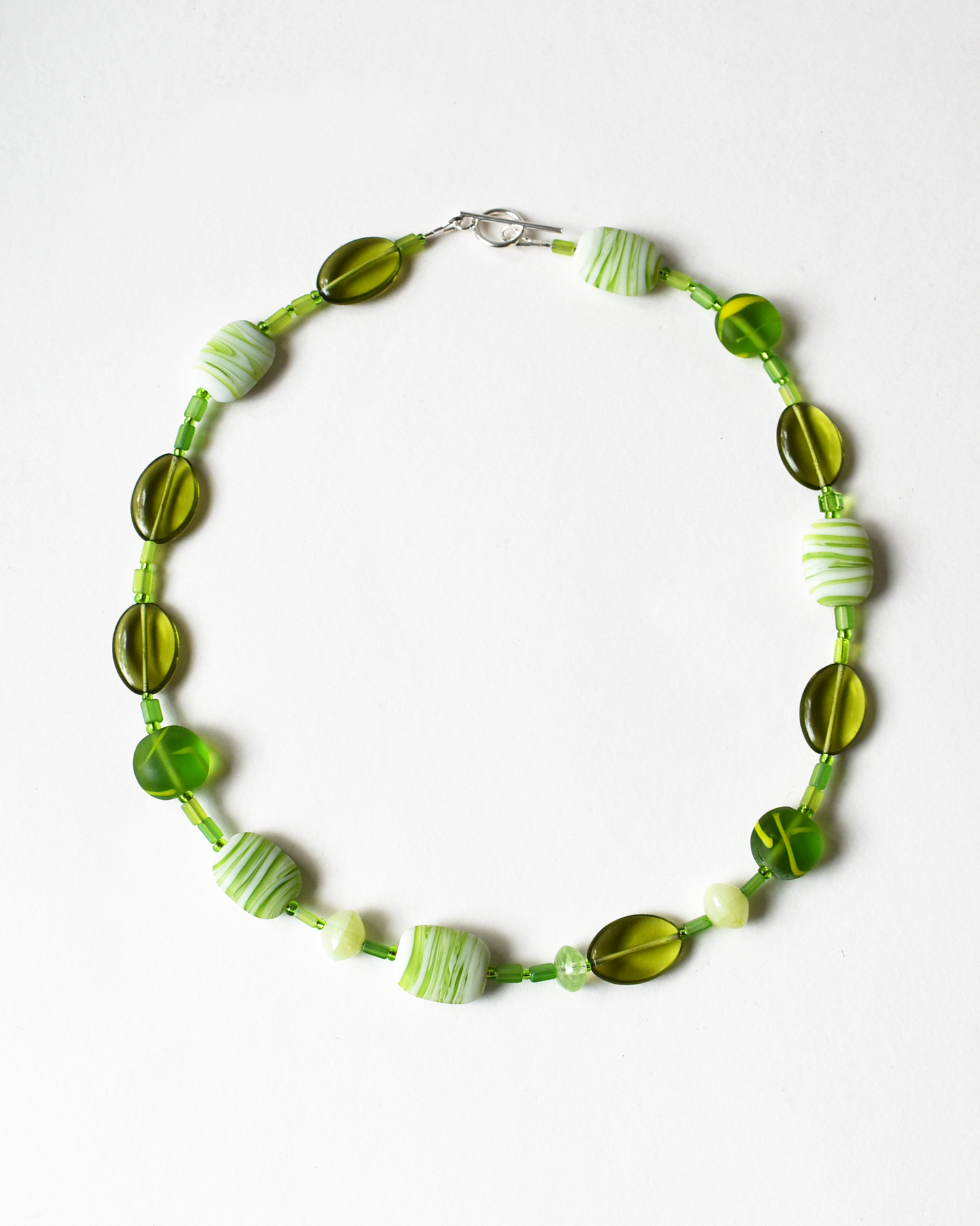 Necklace with green beads on a white background