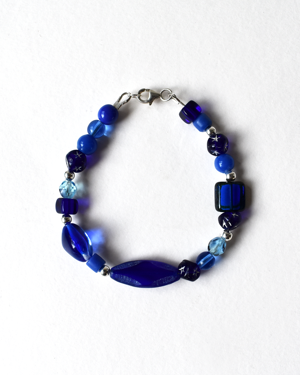 Blue beaded bracelet on a white background