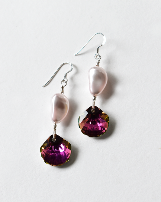 Pair of earrings with pink and purple gemstones on a white background