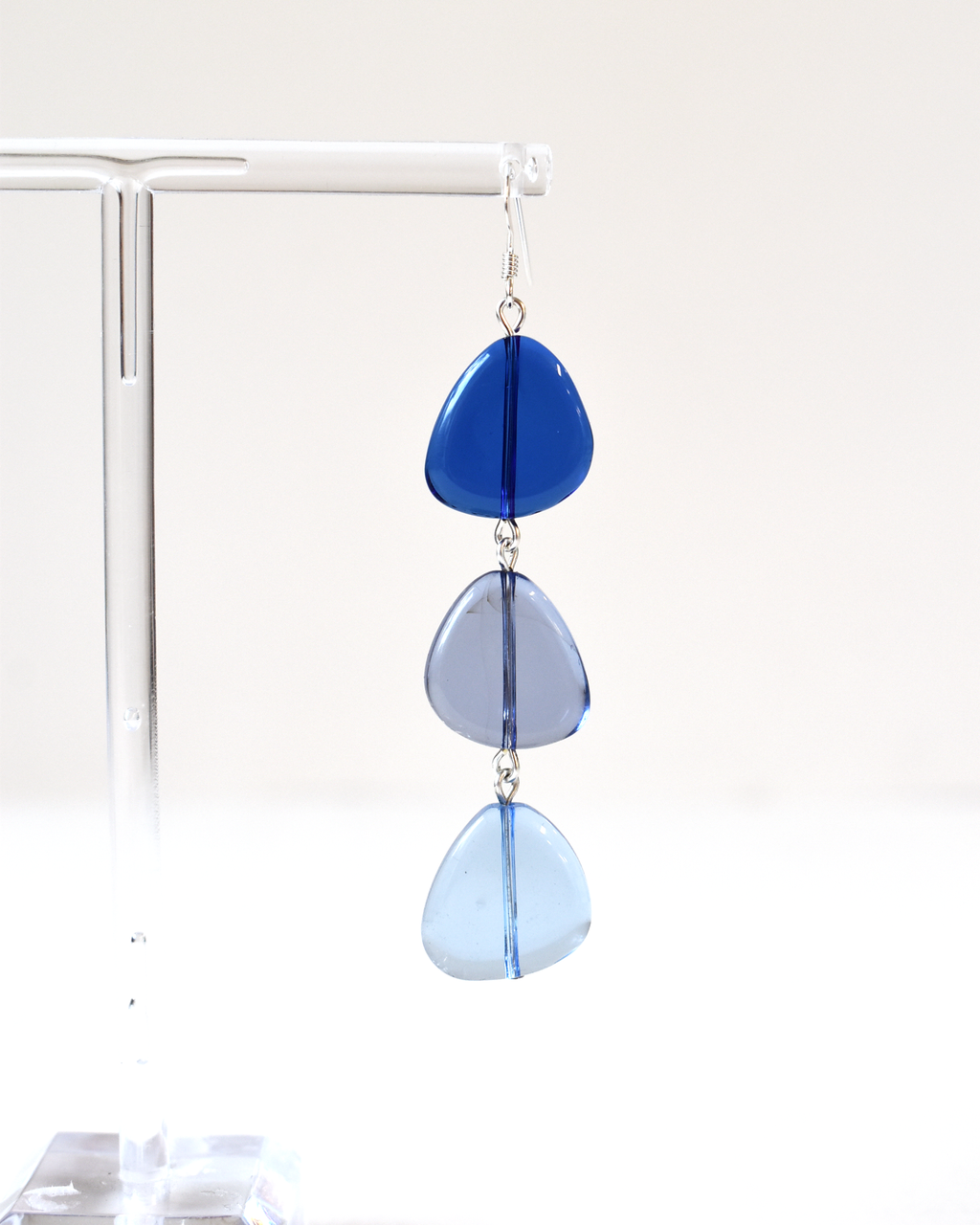 Blue teardrop-shaped earrings on a white background