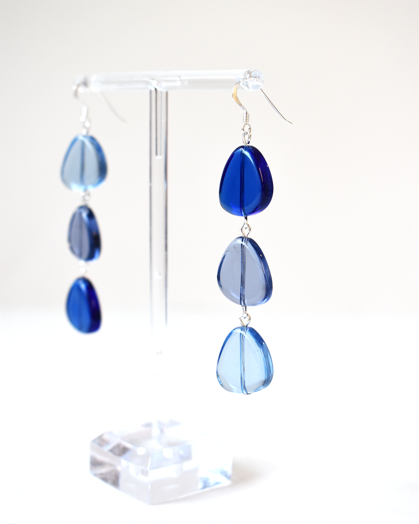 Blue teardrop earrings on a white background