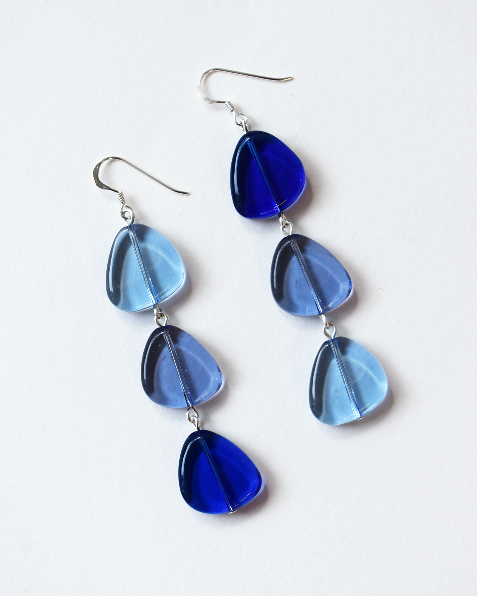 Blue teardrop earrings on a white background