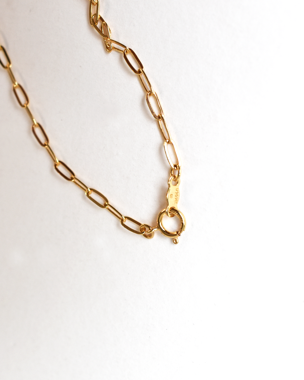Gold chain necklace on a white background