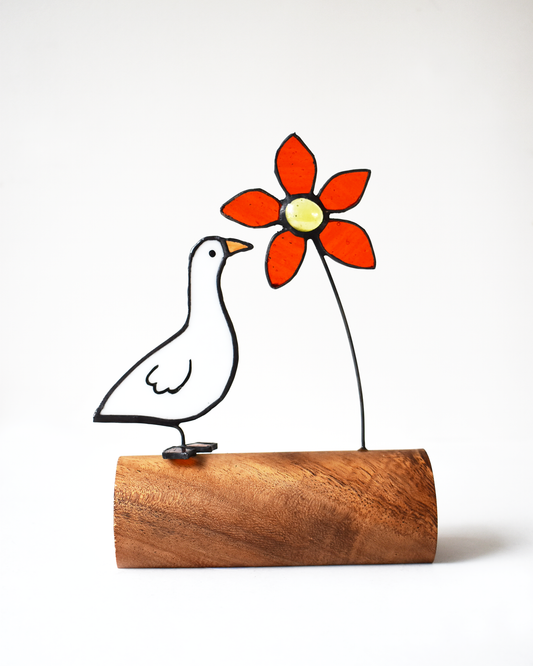 Decorative piece with a bird and red flower on a white background