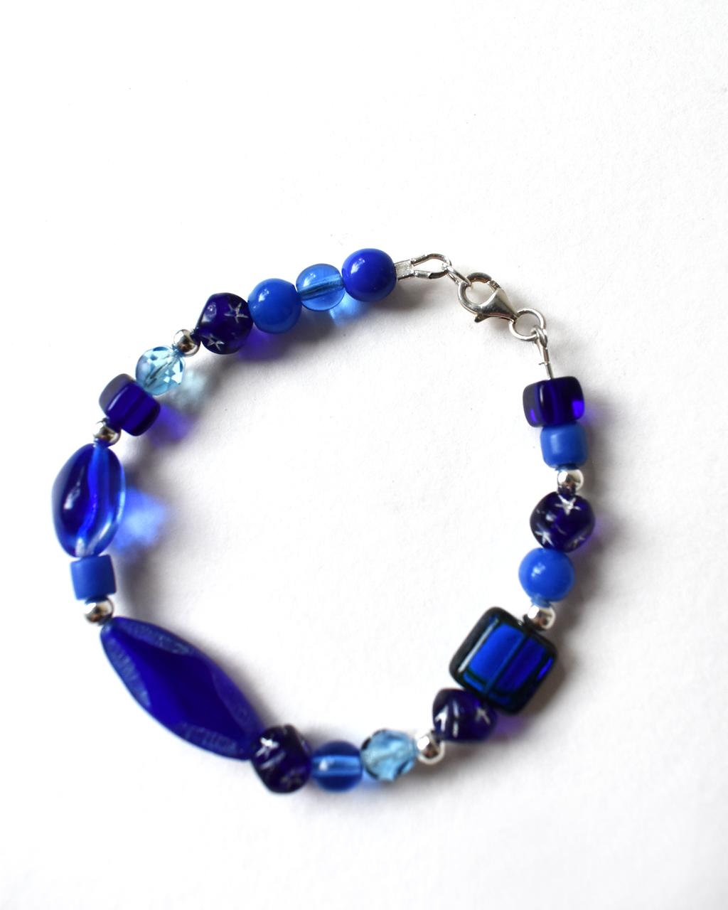 Blue beaded bracelet on a white background