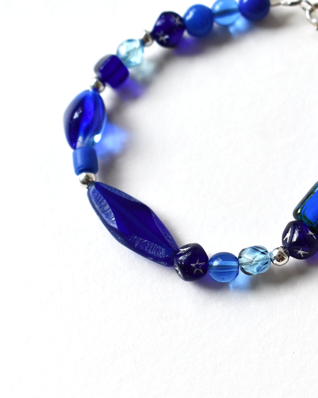 Blue beaded necklace on a white background