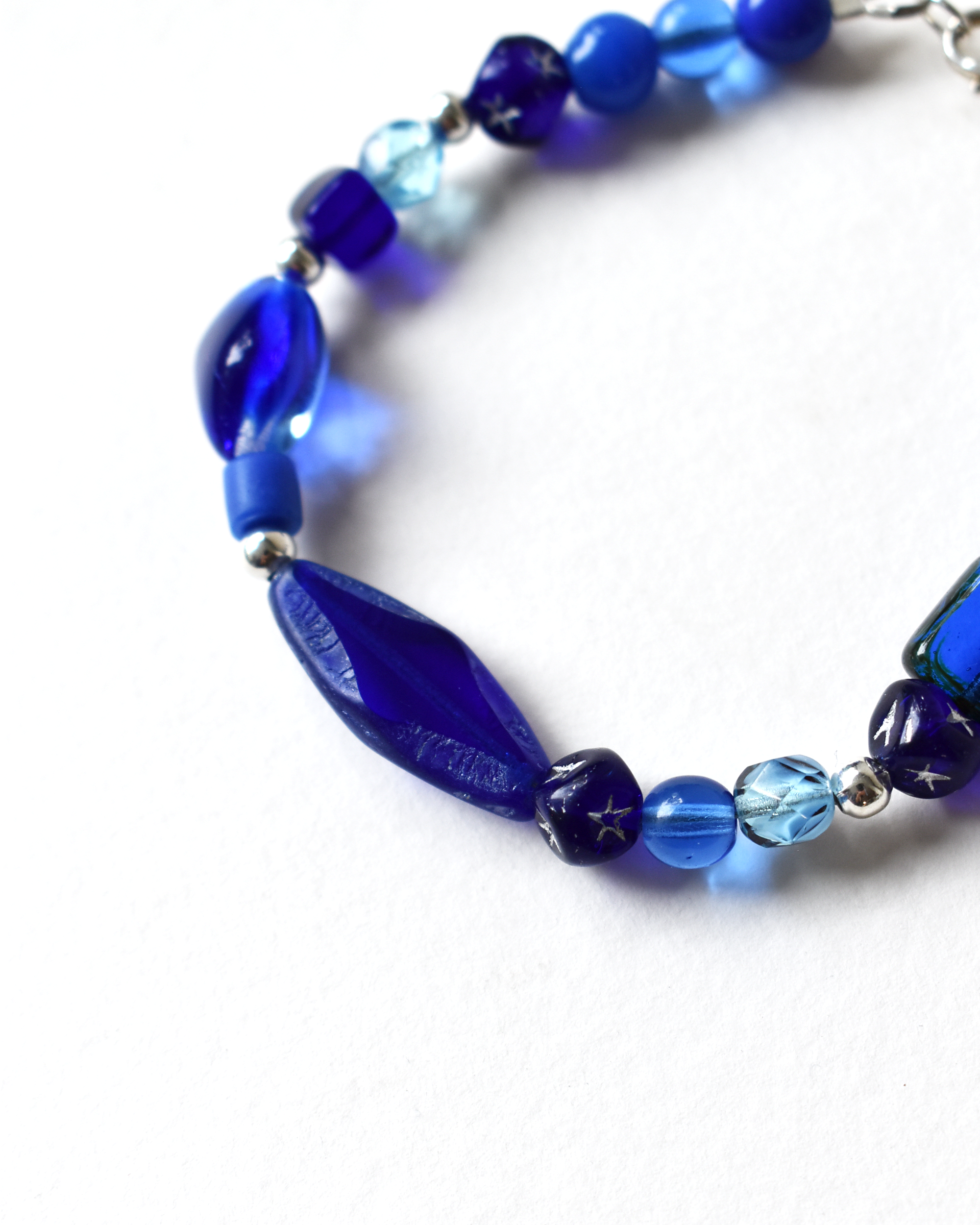Blue beaded necklace on a white background