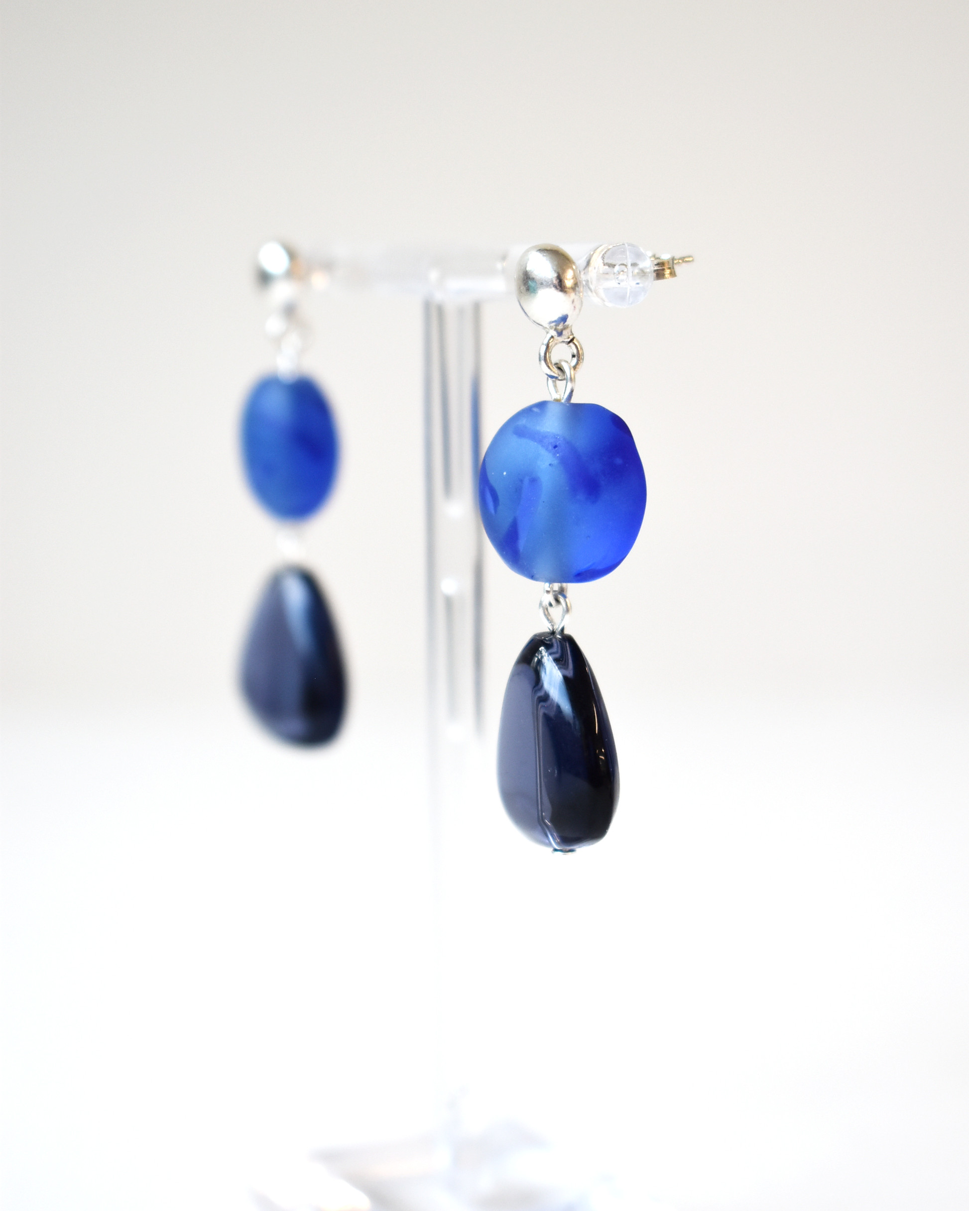Blue teardrop earrings on a white background